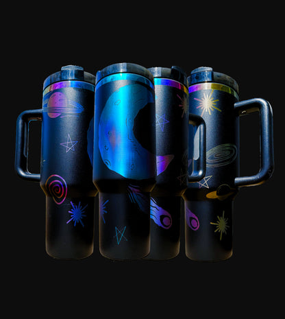 40oz iridescent black "The Dreamer" tumbler with laser engraved view of moon in space along with comets, stars and other space artifacts, shown from four angles.