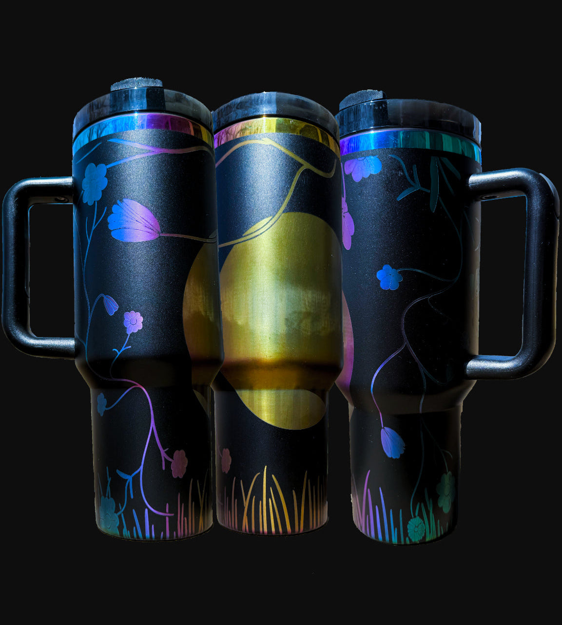 40oz iridescent black "The Hidden" tumbler with laser engraved view of moon over grass and between small branches, shown from three angles
