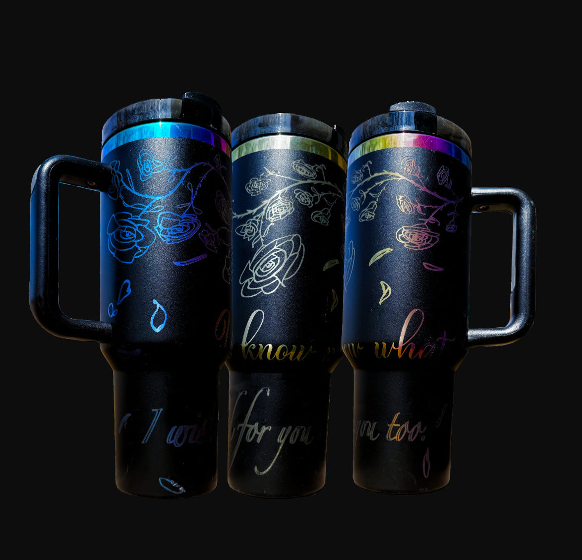 40oz iridescent black "The Spellbound" tumbler with laser engraved view of roses and rose petals falling over the words "You know what? I wished for you too" shown from three angles.