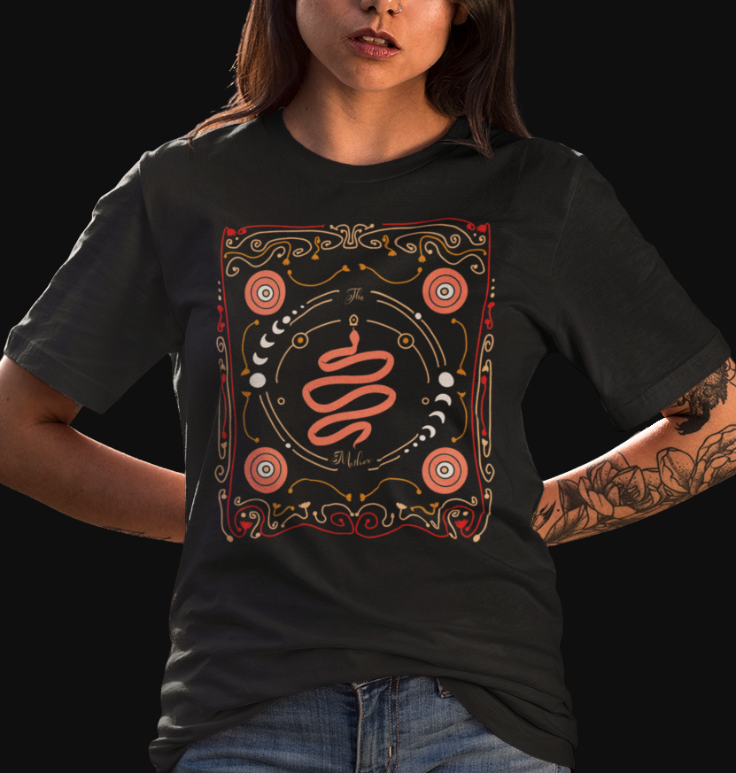 Black "The Imbued" graphic tee with intricate design of patterns, moon phases, and snake with the words "The Mother" printed on front. 