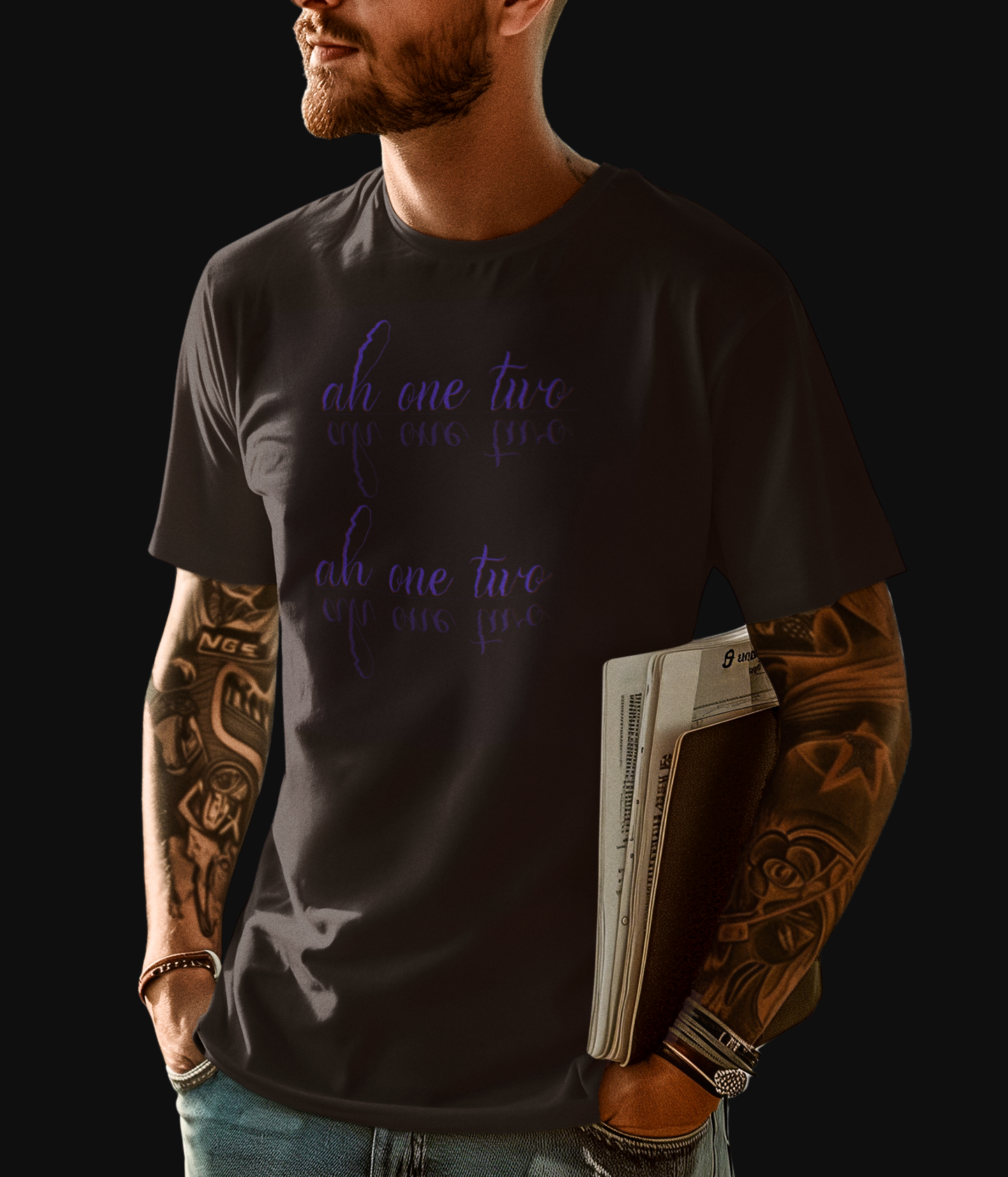 Black "The Warm Up" graphic tee with the words " ah one two" printed in two lines, the words have a mirrored reflection underneath each line printed on front