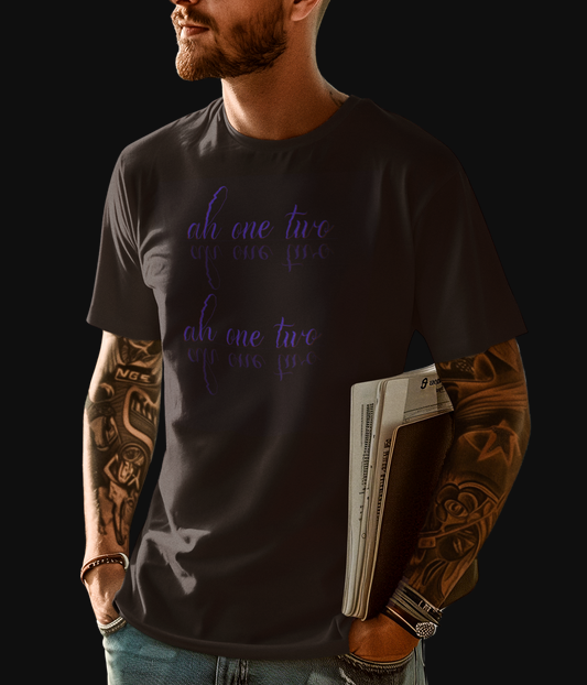 Black "The Warm Up" graphic tee with the words " ah one two" printed in two lines, the words have a mirrored reflection underneath each line printed on front